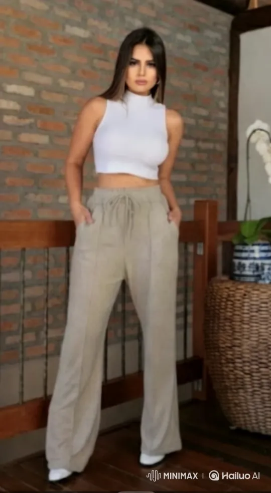 Woman in White Crop Top Poses Against Brick Wall – AI Generated Video | Hailuo AI