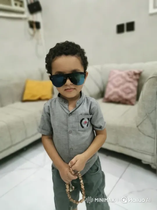 Boy in Modern Living Room with Bead Necklace – AI Generated Video | Hailuo AI