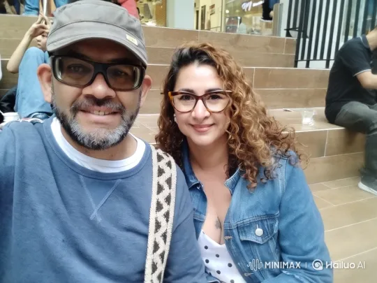 Couple Relaxing Amidst Bustling Mall Atmosphere – AI Generated Video | Hailuo AI
