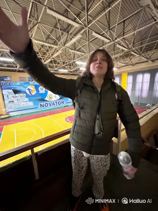 Young Man Fleeing Through Bright Arena Followed by Five Men – AI Generated Video | Hailuo AI