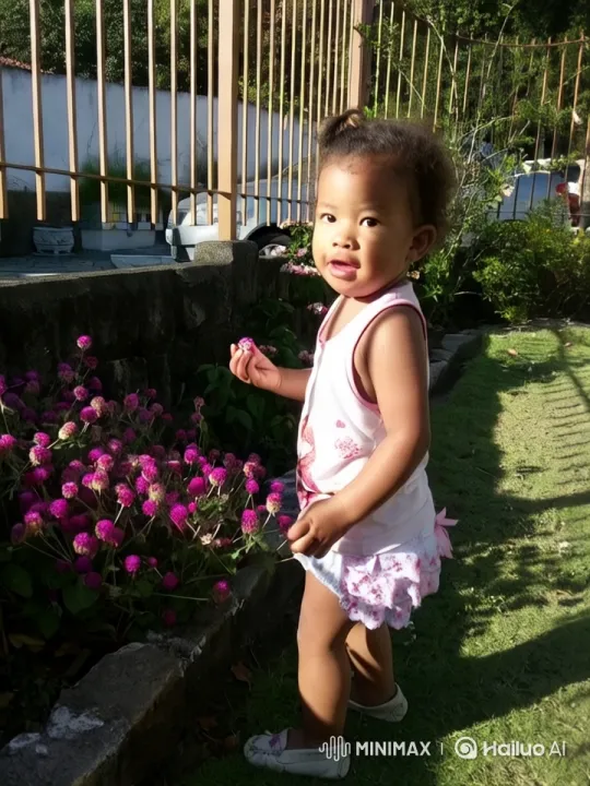Child Dancing in Flower-Filled Garden – AI Generated Video | Hailuo AI