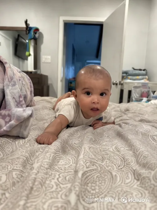 Baby's Gentle Efforts in a Cozy Bedroom Setting – AI Generated Video | Hailuo AI
