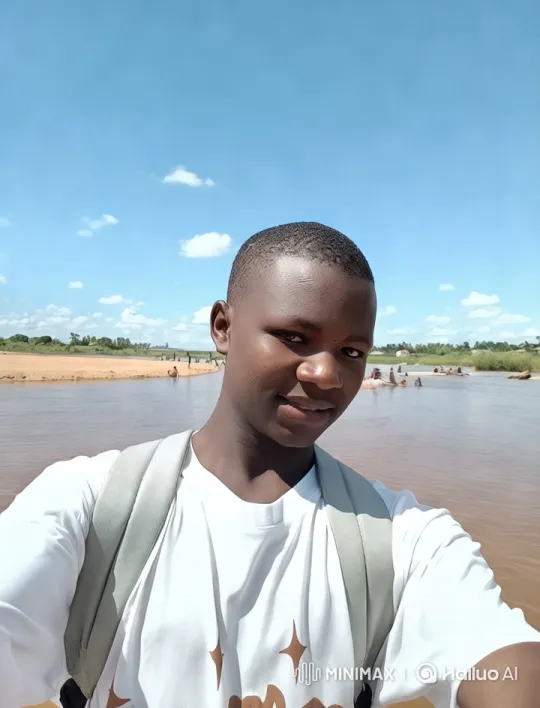 Young Man by River Amidst Scenic Nature and Leisure – AI Generated Video | Hailuo AI