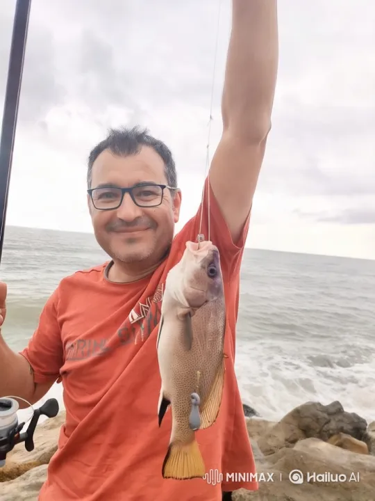 Man Catches, Kisses, and Releases Fish in Serene Coastal Scene – AI Generated Video | Hailuo AI