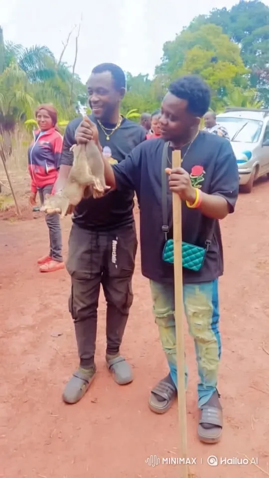 Man Proudly Displays Rats Amidst Nature and Gathered Spectators – AI Generated Video | Hailuo AI