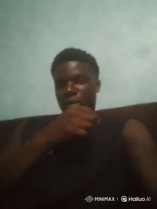 Close-up of Person Reflecting on Couch in Soft-Lit Room – AI Generated Video | Hailuo AI
