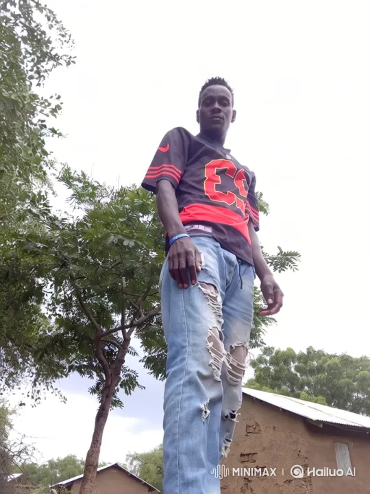 Confident Young Man in Black and Red Jersey Under Overcast Sky – AI Generated Video | Hailuo AI