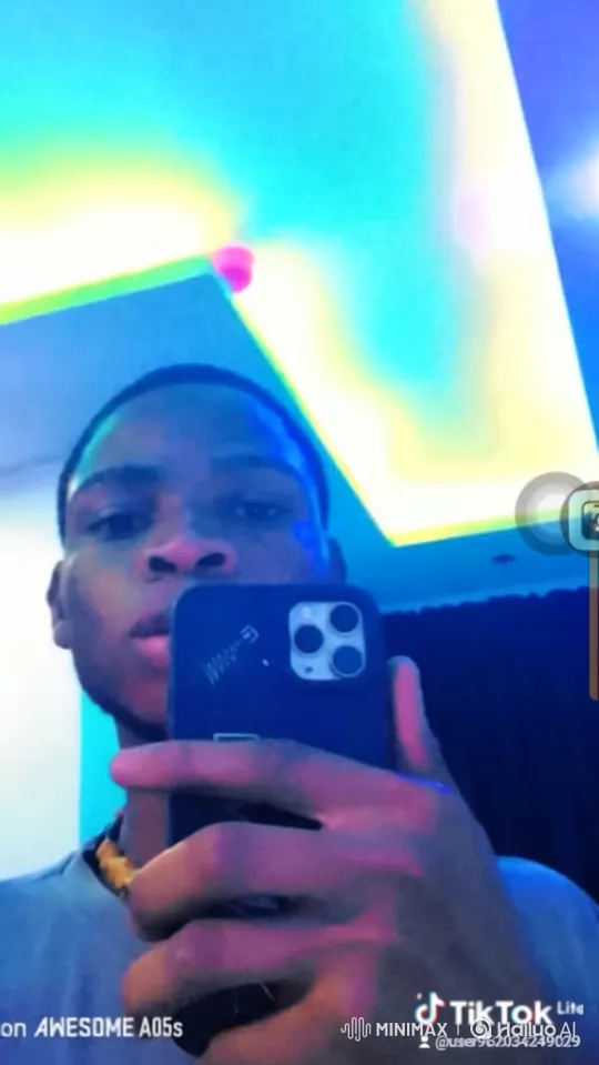 Young Black Man Films Himself in Colorful Mirror Selfie – AI Generated Video | Hailuo AI