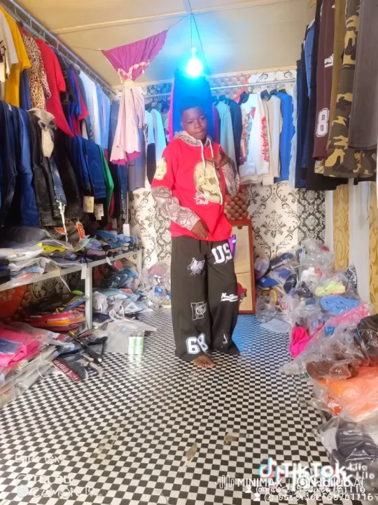Young Person Poses Confidently in Clothing Shop – AI Generated Video | Hailuo AI