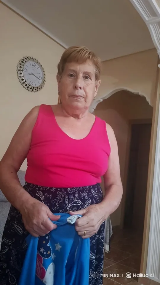 Elderly Woman Folding Child's Sweatshirt at Home – AI Generated Video | Hailuo AI