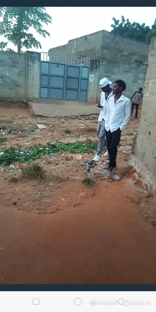 Young Men in Dirt Yard Engage in Quiet Conversation – AI Generated Video | Hailuo AI