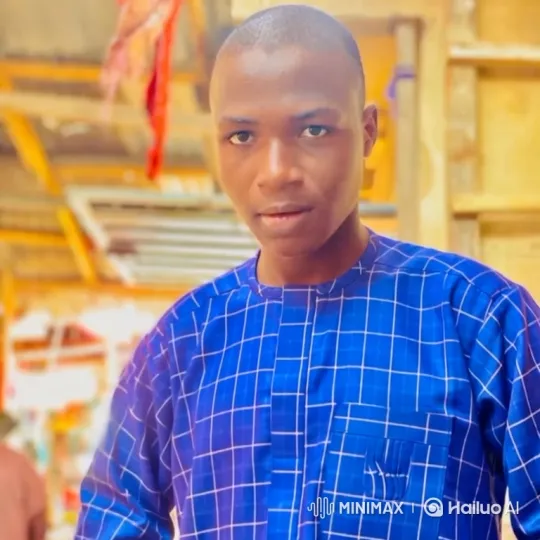 Young Man in Blue Tunic Smiles Gently – AI Generated Video | Hailuo AI