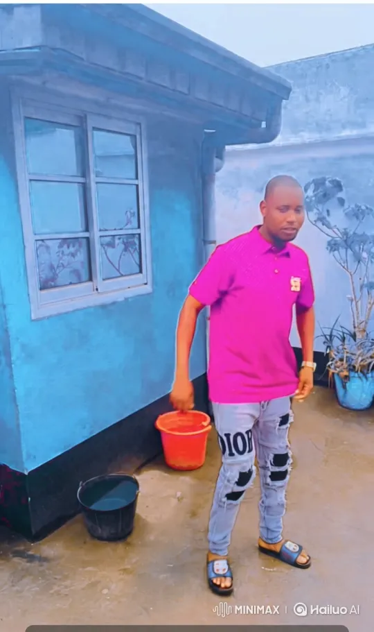 Man in Pink Shirt on Wet Concrete: Tracking Shot – AI Generated Video | Hailuo AI