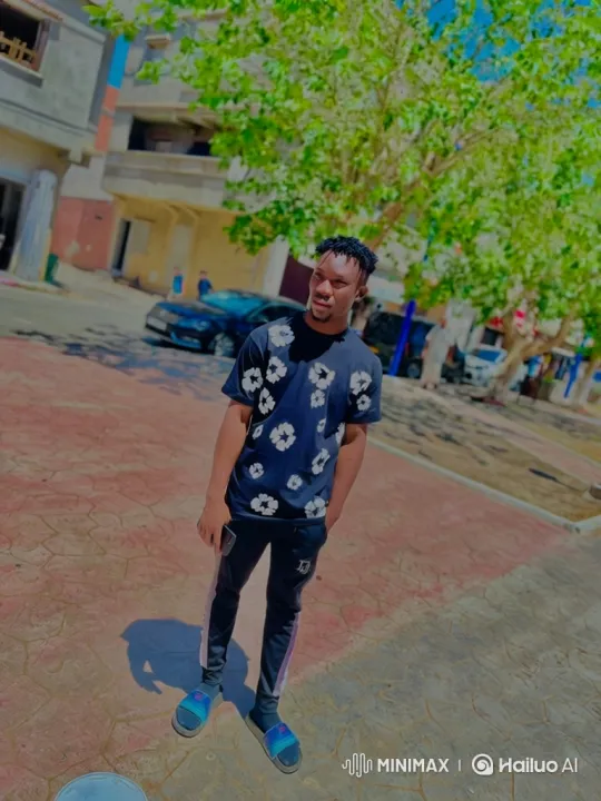 Young Man on Sunny Walkway with Gentle Smile – AI Generated Video | Hailuo AI