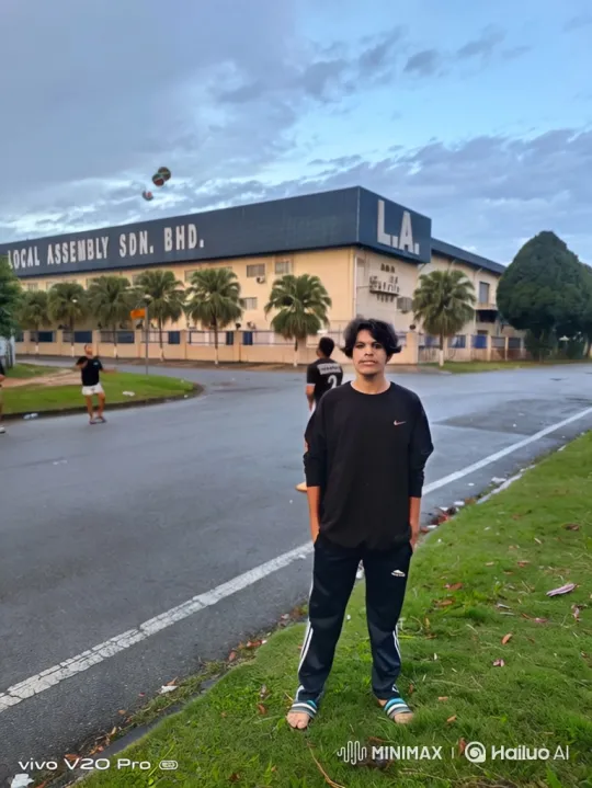 Young Man Walks in Gentle Rain by Local Assembly Building – AI Generated Video | Hailuo AI