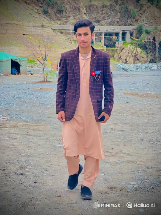 Young Man Walks Towards Camera in Mountainous Landscape – AI Generated Video | Hailuo AI