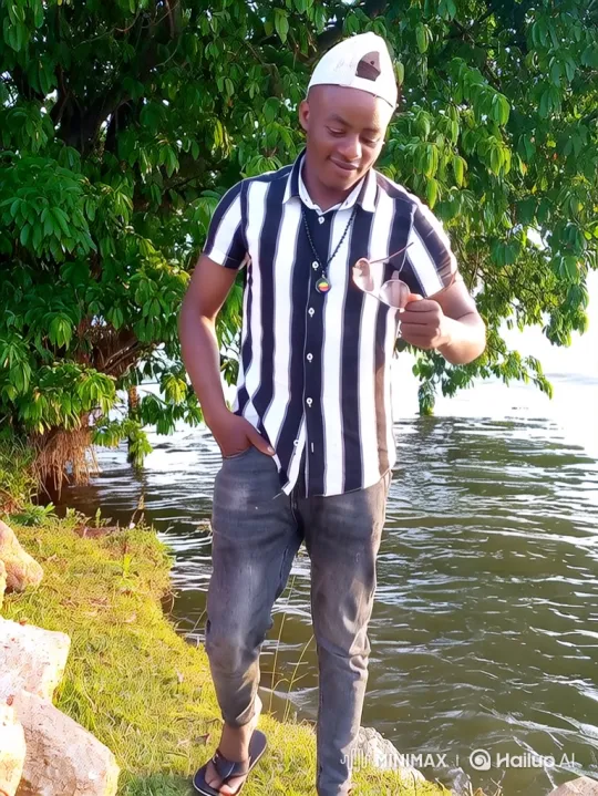 Young Man Enjoying Peaceful Water View with Sunglasses – AI Generated Video | Hailuo AI