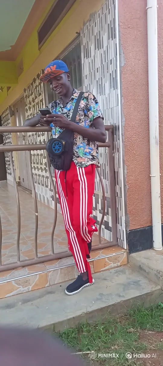 Young Man Smiling, Engaged with Phone – AI Generated Video | Hailuo AI