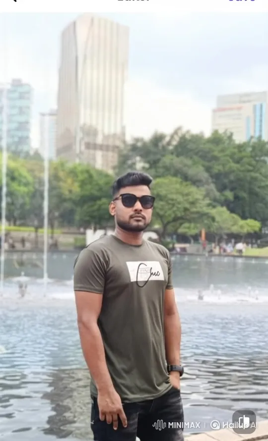 Young Man in City Park Amidst Fountains and Greenery – AI Generated Video | Hailuo AI
