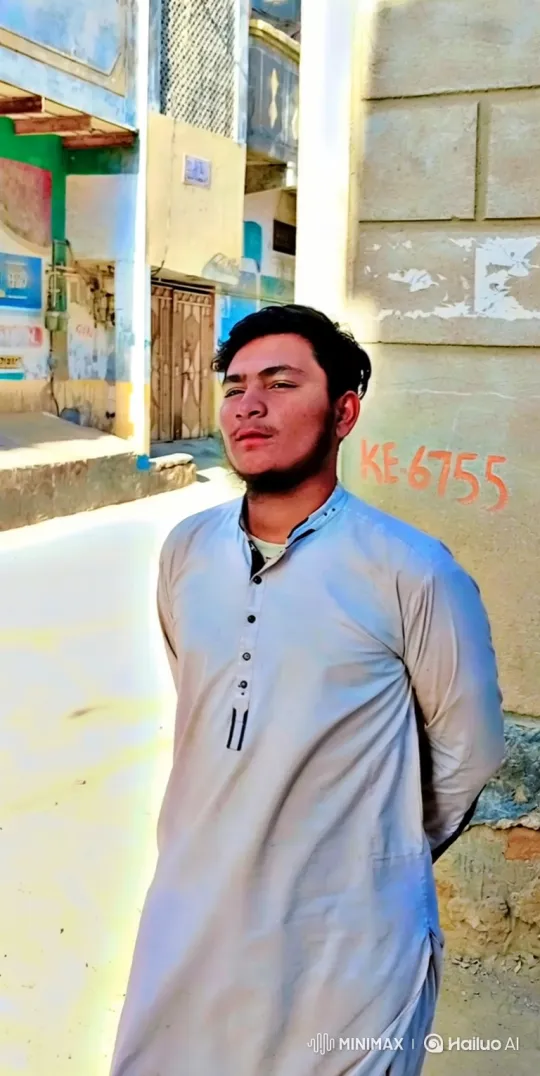 Contemplative Young Man in Sunlit Alley – AI Generated Video | Hailuo AI