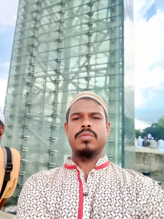 Man with Red Trim Shirt and Cap Smiles Gently – AI Generated Video | Hailuo AI