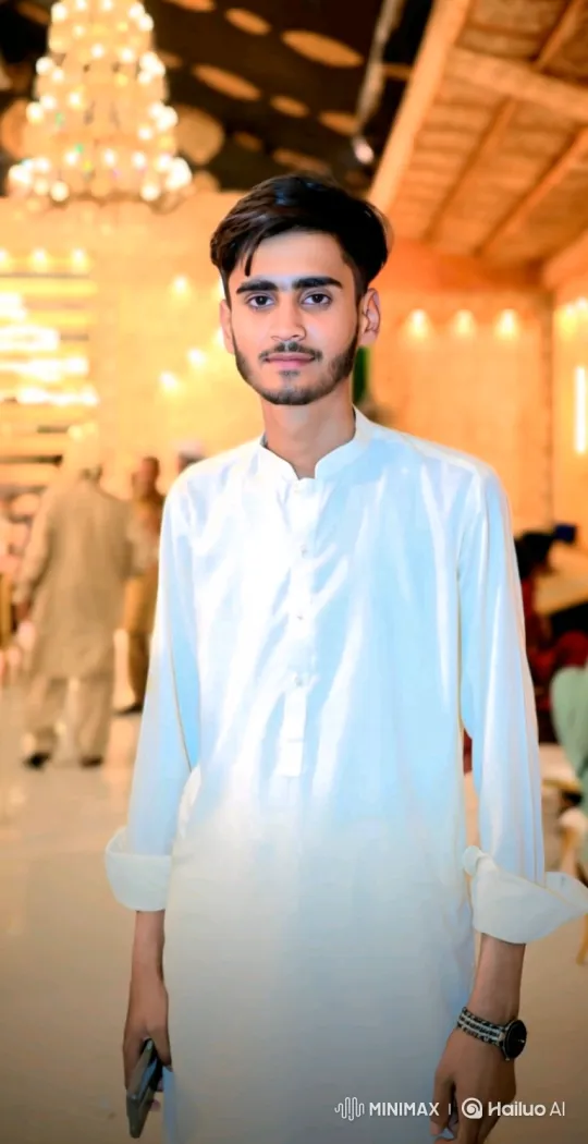 Young Man in Festive Hall: A Subtle Smile – AI Generated Video | Hailuo AI