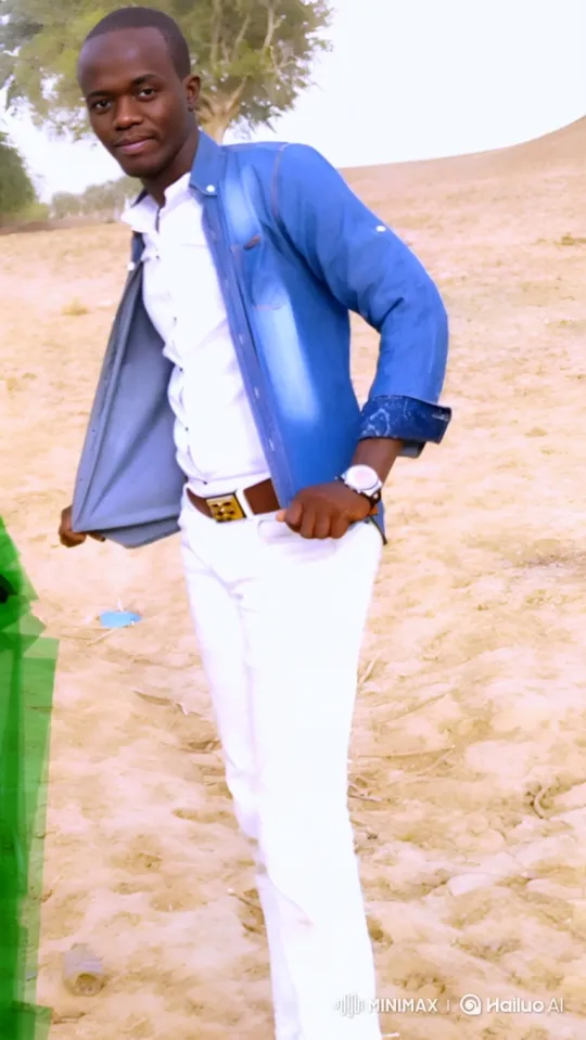 Stylish Young Man Poses Confidently in Sandy Landscape – AI Generated Video | Hailuo AI