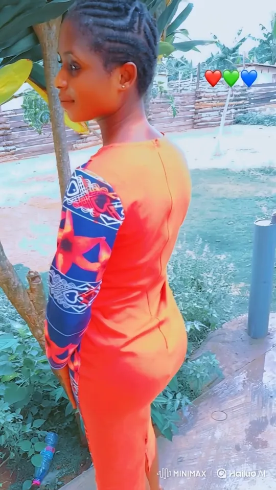 Young Woman in Orange Dress Walks Gracefully in Yard – AI Generated Video | Hailuo AI