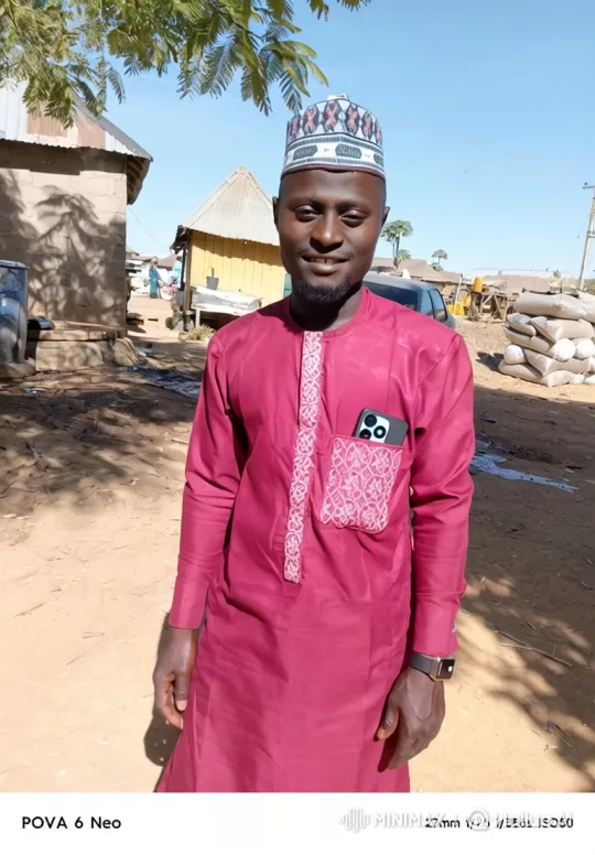 Man in Maroon Garment with Embroidery Smiles at Camera – AI Generated Video | Hailuo AI