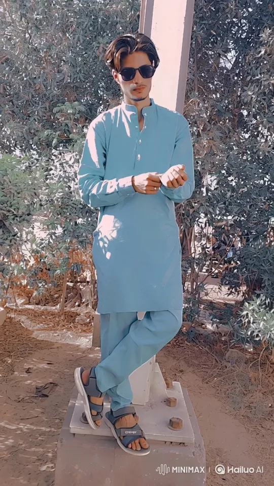 Young Man in Blue Attire Amidst Greenery – AI Generated Video | Hailuo AI