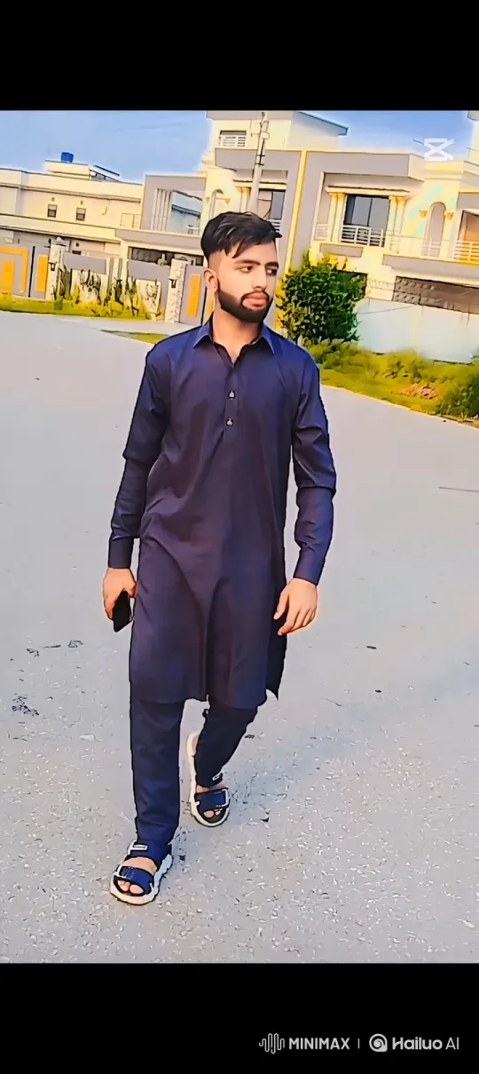 Young Man in Blue Tunic Walks Down Residential Street – AI Generated Video | Hailuo AI