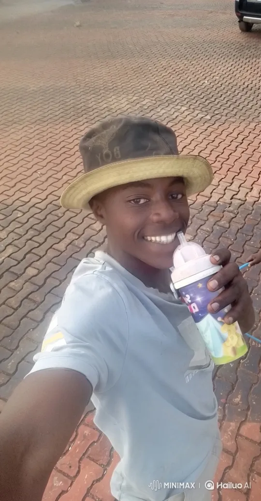 Young Man Smiles, Sips from Sippy Cup – AI Generated Video | Hailuo AI