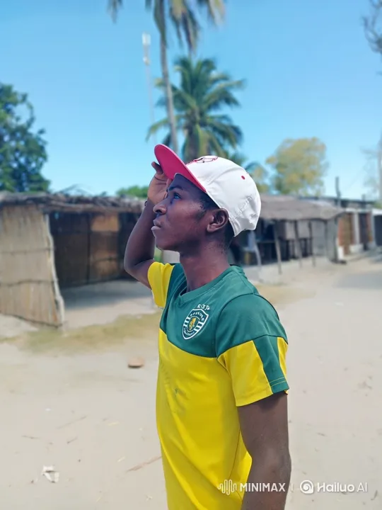 Young Man in Sandy Village Contemplates Horizon – AI Generated Video | Hailuo AI