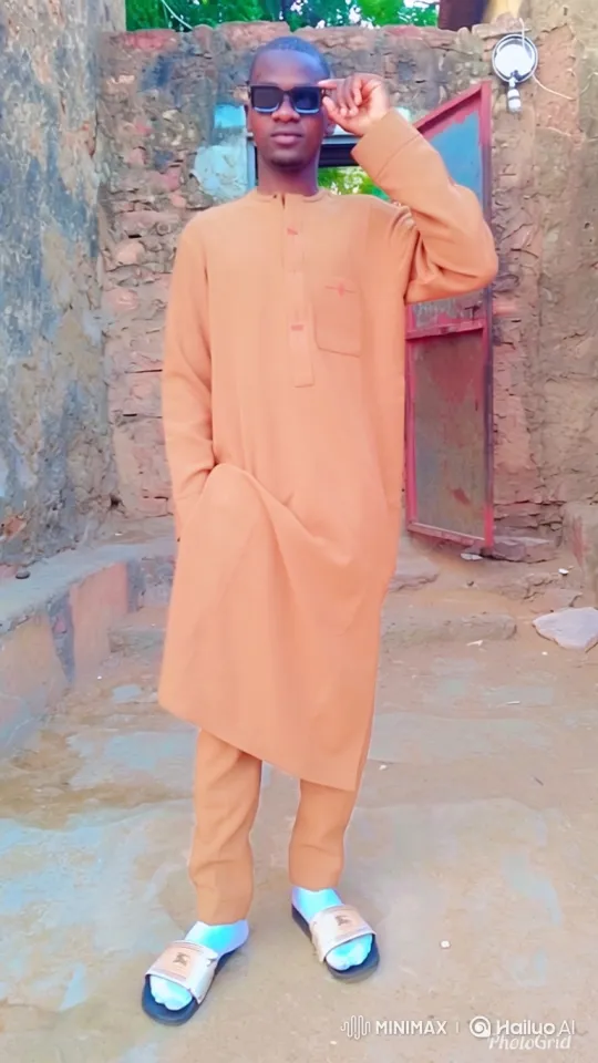 Young Man in Tan Outfit Walks Confidently Across the Outdoor Area – AI Generated Video | Hailuo AI