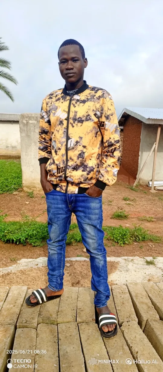 Young Man in Bomber Jacket Smiles Gently in Outdoor Setting – AI Generated Video | Hailuo AI