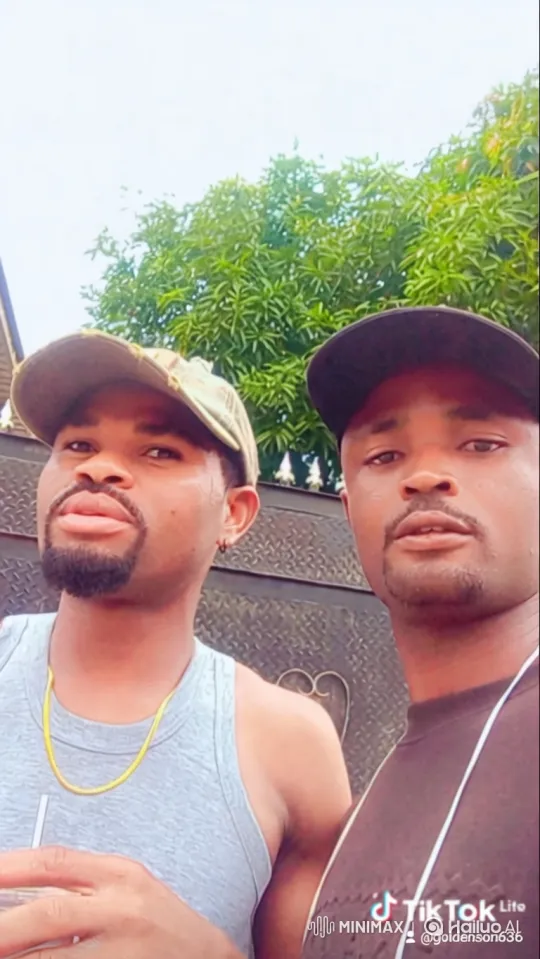Two Men Stand Before Gate in Overcast Day – AI Generated Video | Hailuo AI