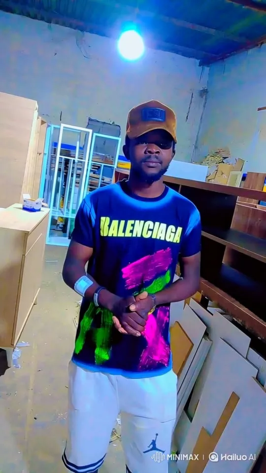 Young Man in Furniture Workshop with Slow Camera Pan – AI Generated Video | Hailuo AI