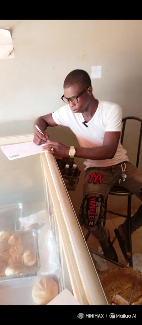 Young Man Intently Writing in a Quiet Space – AI Generated Video | Hailuo AI