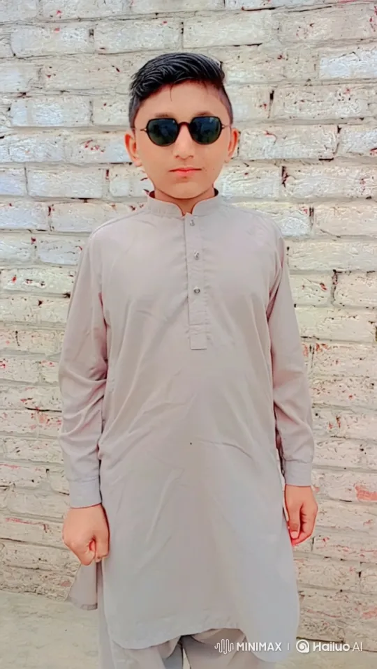 Young Boy in Traditional Attire Makes a Phone Call – AI Generated Video | Hailuo AI
