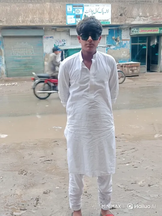 Young Man Stands Calmly on Rainy Urban Street – AI Generated Video | Hailuo AI