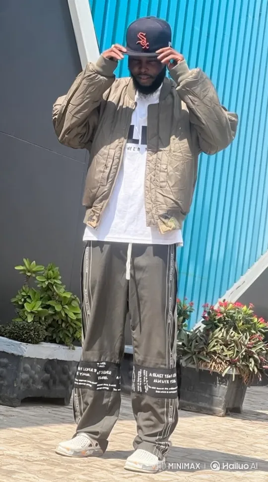 Man Adjusts Cap, Stands Calmly in Colorful Streetwear – AI Generated Video | Hailuo AI