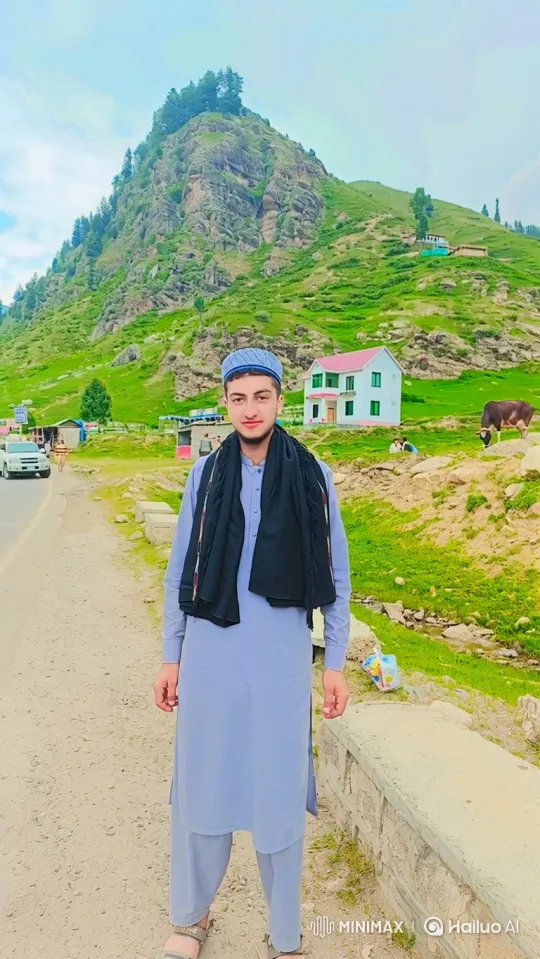 Young Man in Serene Mountain Valley Amidst Gentle Breeze – AI Generated Video | Hailuo AI