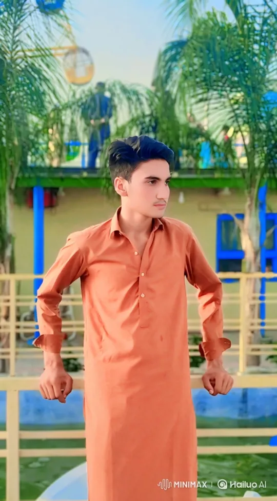 Young Man Smiles in Park with Swaying Palm Trees – AI Generated Video | Hailuo AI