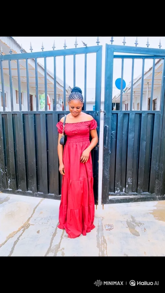 Young Woman in Red Dress at Metal Gate – AI Generated Video | Hailuo AI