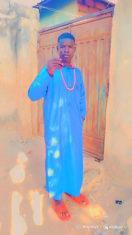 Young Man in Vibrant Blue Tunic in Sunny Outdoor Setting – AI Generated Video | Hailuo AI