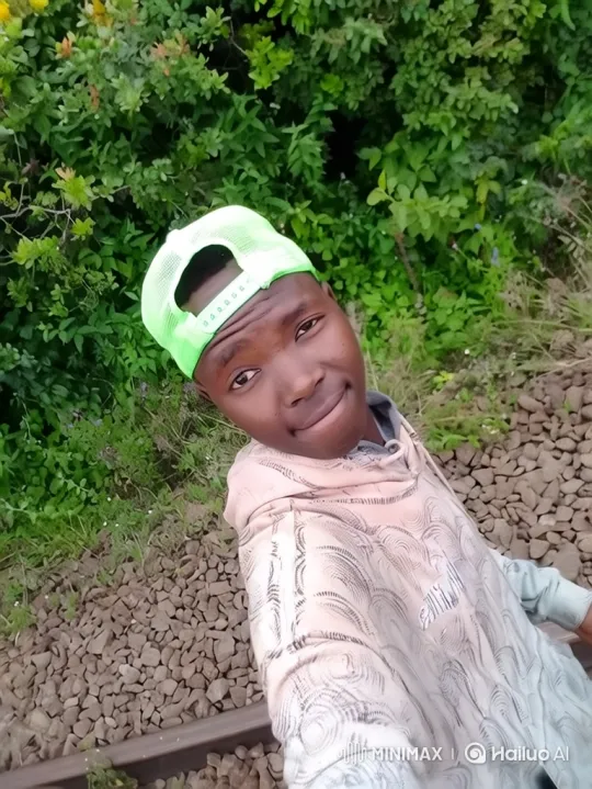 Young Man Smiles by Railway Track – AI Generated Video | Hailuo AI