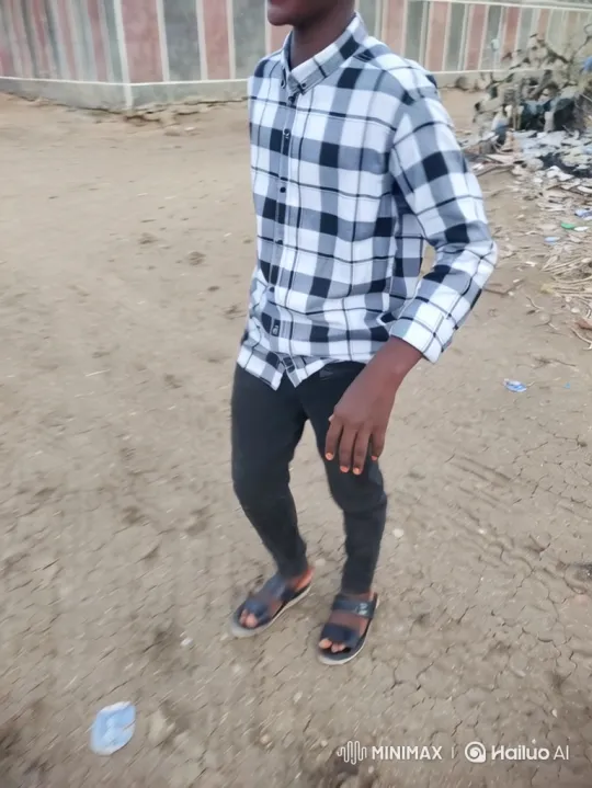 Person Walking on Dry Path with Striped Wall Background – AI Generated Video | Hailuo AI