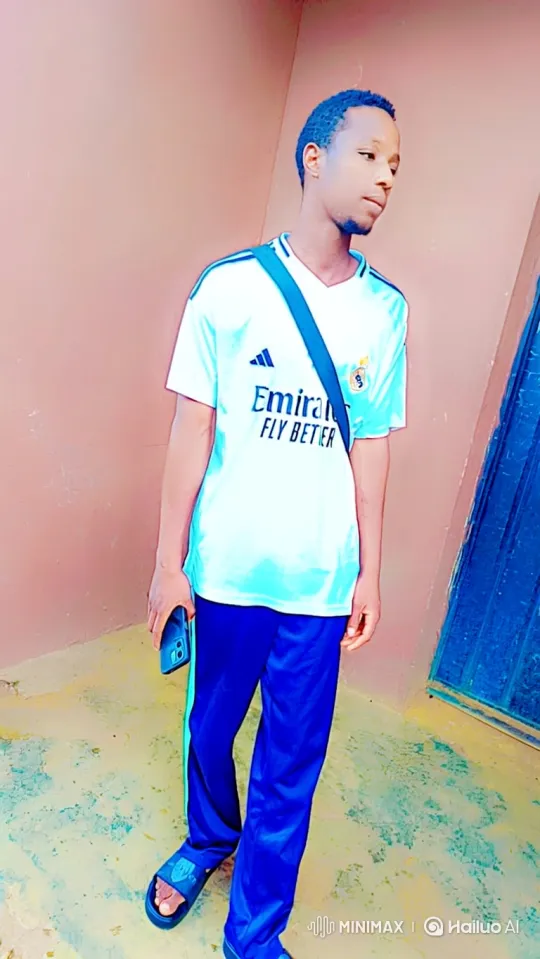 Young Man Contemplates with Phone Beside Wall – AI Generated Video | Hailuo AI