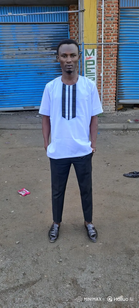 Man in White Tunic Stands Still, Smiles Subtly – AI Generated Video | Hailuo AI