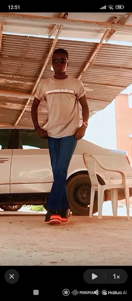 Confident Young Man Stands Under Carport, Enduring Afternoon Sun – AI Generated Video | Hailuo AI